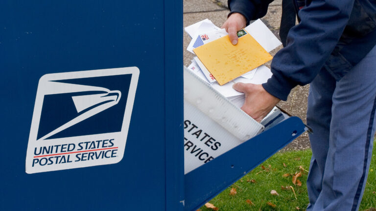 USPS financial condition “continues to worsen”, reports PRC USPS postal worker collecting mail from mailbox