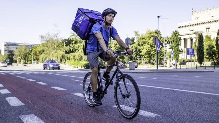 Stuart courier on a bicycle.