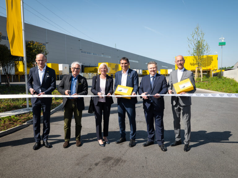 Austrian Post officials cutting the ribbon at the opening of the new parcel logistics center in Vienna-Inzersdorf