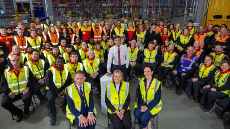 Rishi Sunak in the centre of DHL Supply Chain employees