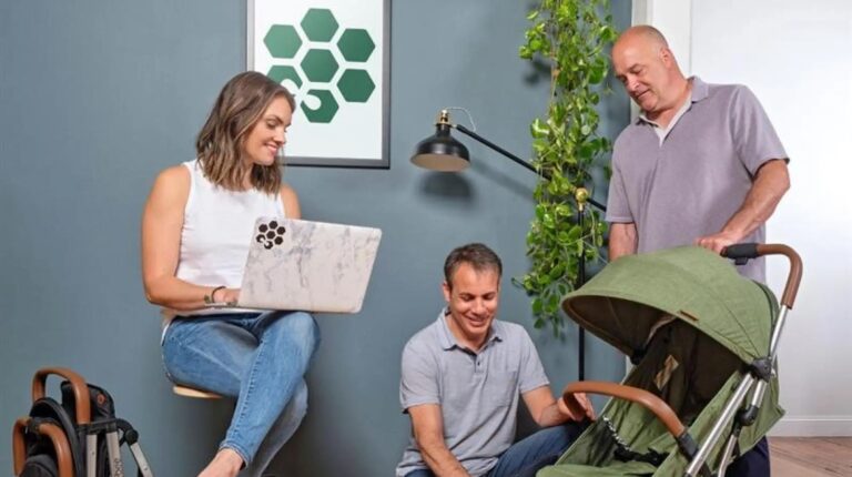 Customers looking at a Bombi stroller.