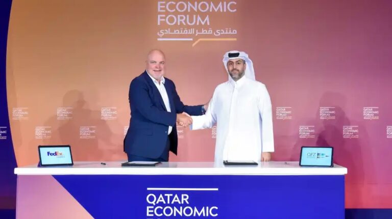 Patrick Moebel, president and CEO, FedEx Logistics shaking hands with Sheikh Mohammed H. F. Al-Thani, CEO of QFZ.