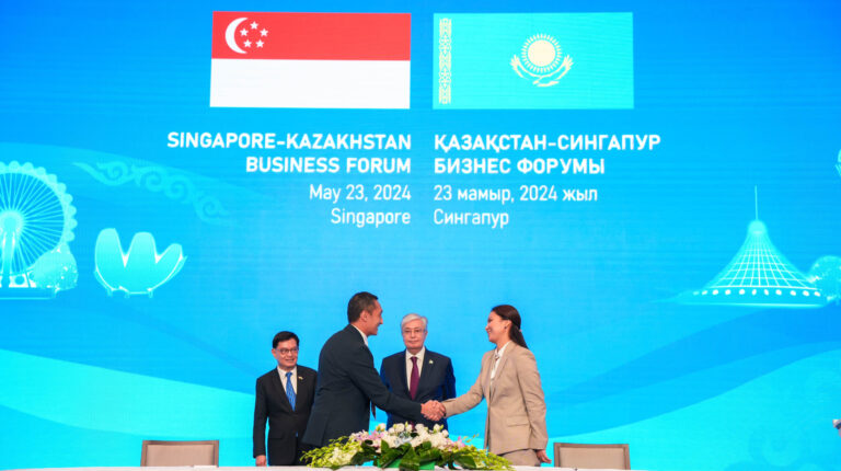L-R: Vincent Phang, Group CEO, Singpost, signs partnership agreement with Asel Zhanassova, Chairman of the Board of JSC QazPost. Witnessed by Deputy Prime Minister and Coordinating Minister for Economic Policies, Singapore, Heng Swee Keat and the President of the Republic of Kazakhstan, Kassym-Jomart Tokayev. Photo credit: Singpost.