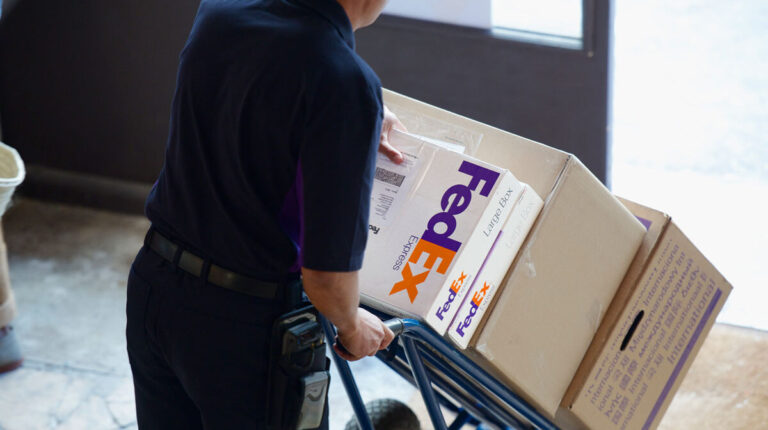 FedEx courier pushing packages