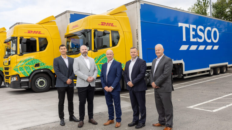 DHL and Tesco staff in front of the new trucks