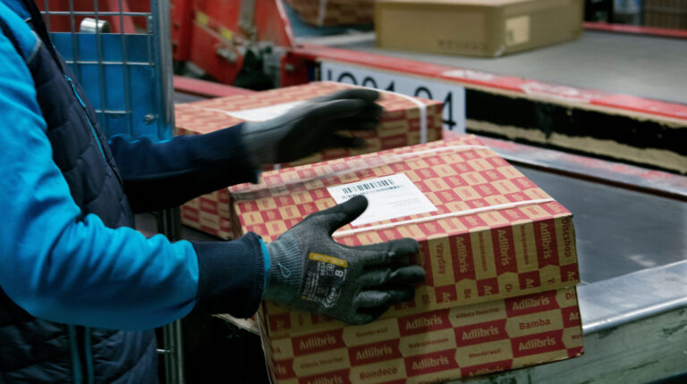 PostNord worker handling a parcel.