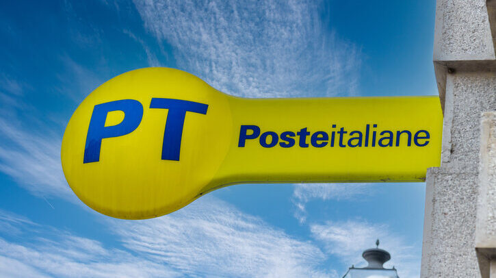 PT Poste Italiane, Italy Post logo on yellow sign on blue sky, outside the Italian post office.