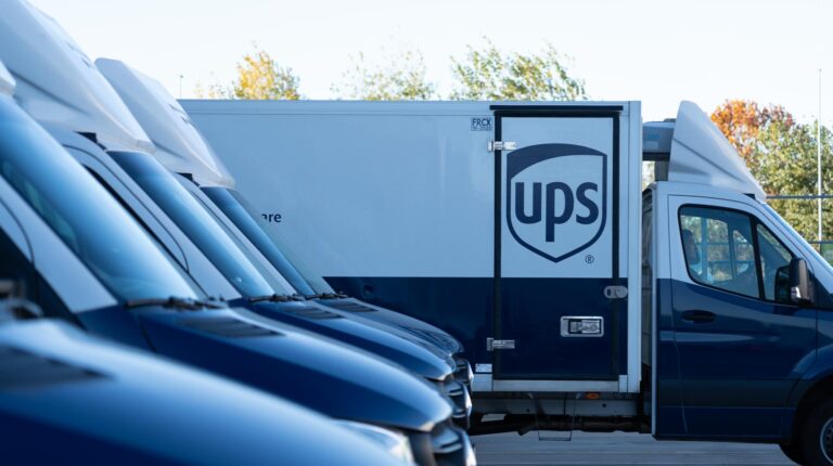 A lineup of the new temperature-controlled UPS fleet with navy and white branding