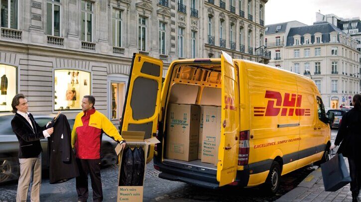 Yellow DHL van with luxury suits in boxes