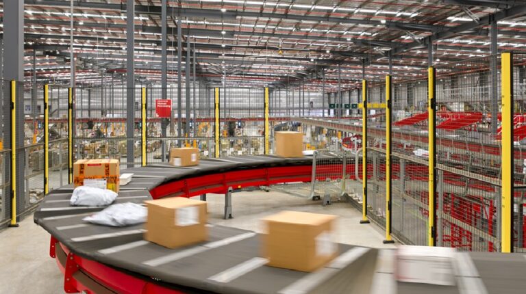 Australia Post parcel facility with parcels on sorting conveyor.