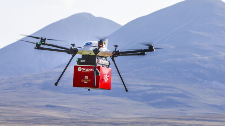 Drone carrying red Royal Mail parcel box