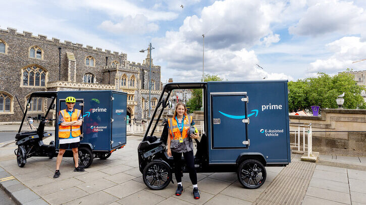 Amazon DNR1e-cargo delivery bikes in front of Norwich Guildhall with two delivery drivers