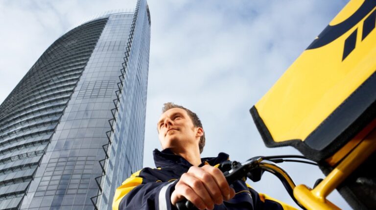 DHL triples operational capacity at Porto Airport with €25m investment DHL worker with high rise building behind him