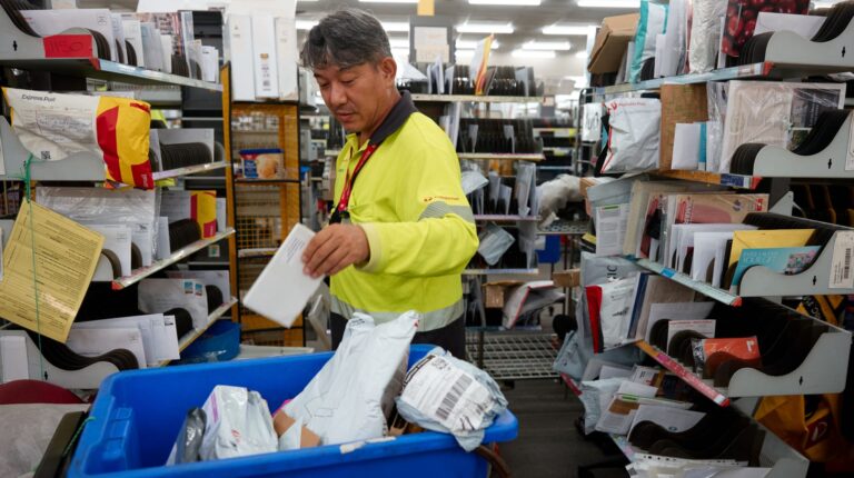 Refugee worker in the Australia Post mail sorting room