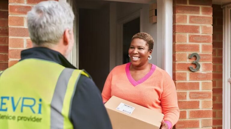 Woman receiving parcel on doorstep from Evri delivery man