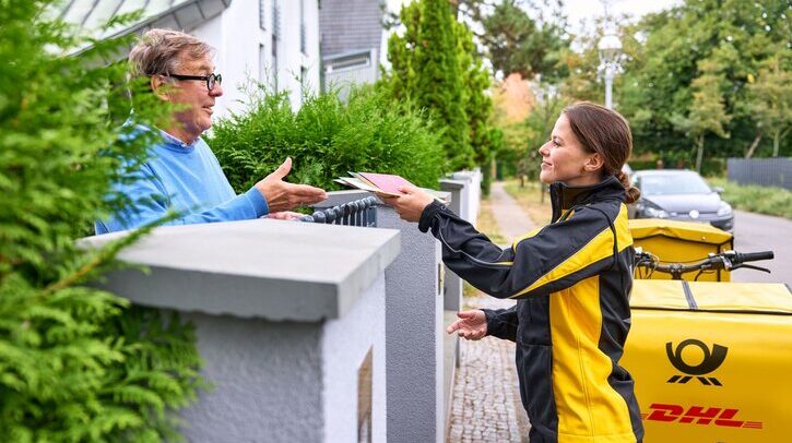 Deutsche Post deliverer delivers letter post.
