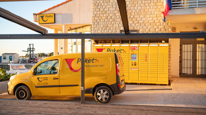 Croatian post office, a yellow branded "Paket 24" car for transporting parcels and a parcel terminal in the town of Novalja on the island of Pag.