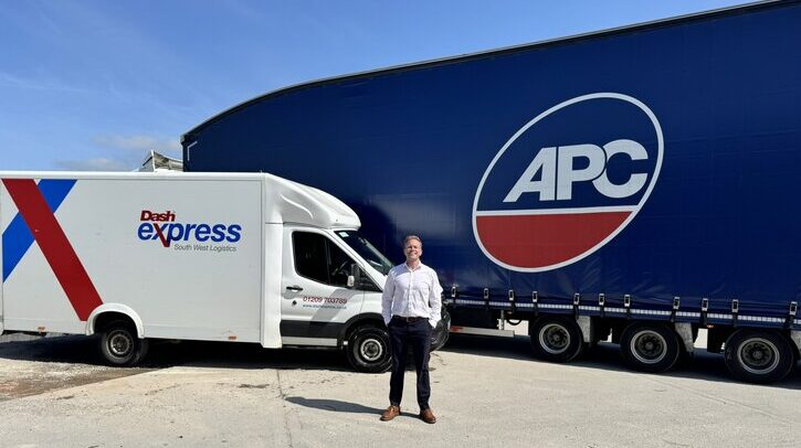 An APC Group van and truck on a tarmac road; Paul Dash, operations director at The Dash Group stands in front.