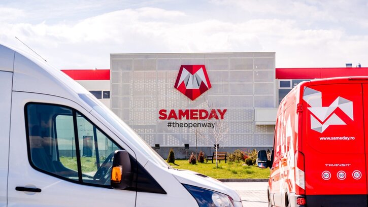 Sameday offices with company logo on the outside, with delivery trucks in front.