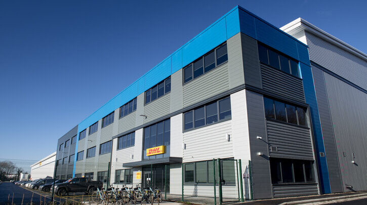 DHL office building with a blue sky behind.