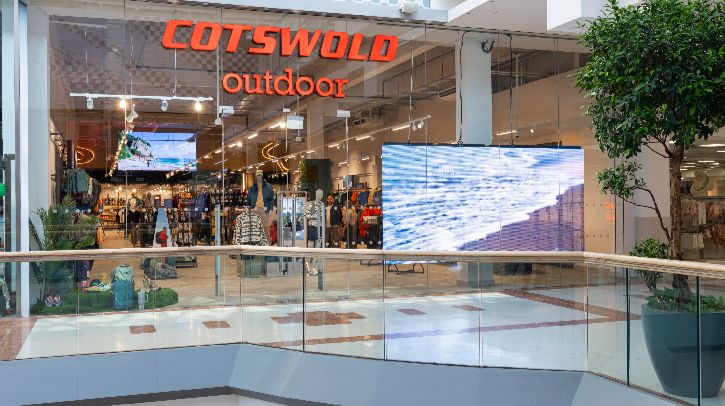 The glass front of a Cotswold Outdoor Group store with name in red lettering