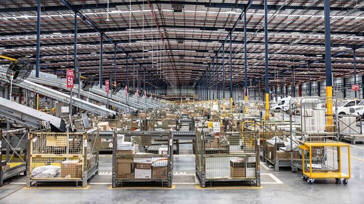 Australia Post announces A$18.8m profit despite substantial letter losses A postal logistics warehouse with cages of post for delivery