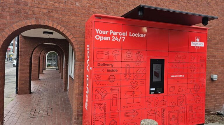 A bank of red Royal Mail parcel lockers at a student residence in the UK