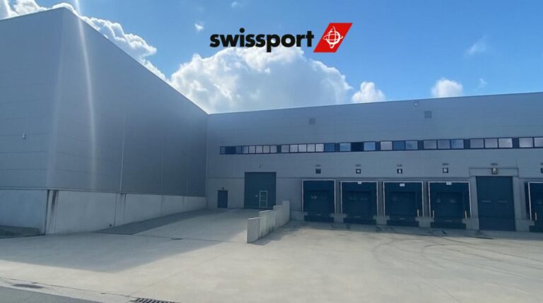 The new Swissport import parcel hub at Liege Airport with a row of loading bays at the front. The sky is blue with scattered clouds