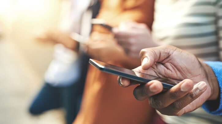 Shot of an unrecognizable group of people social networking outside.